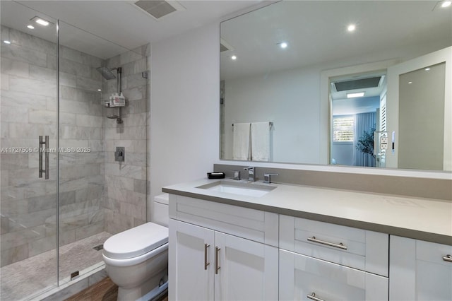 bathroom with a shower with door, hardwood / wood-style flooring, toilet, and vanity