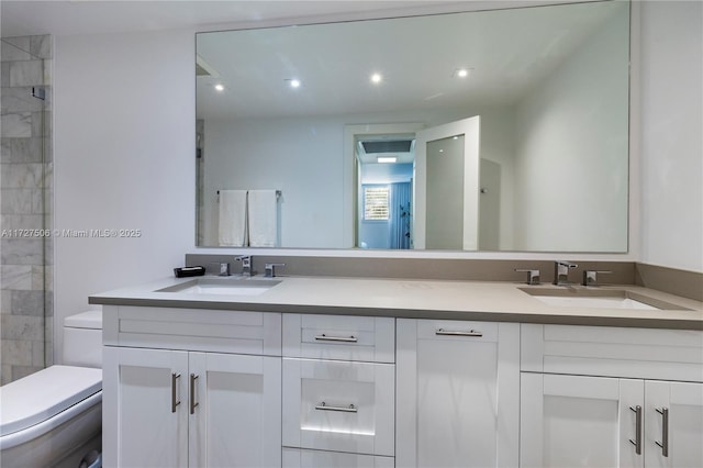 bathroom featuring toilet, vanity, and tiled shower