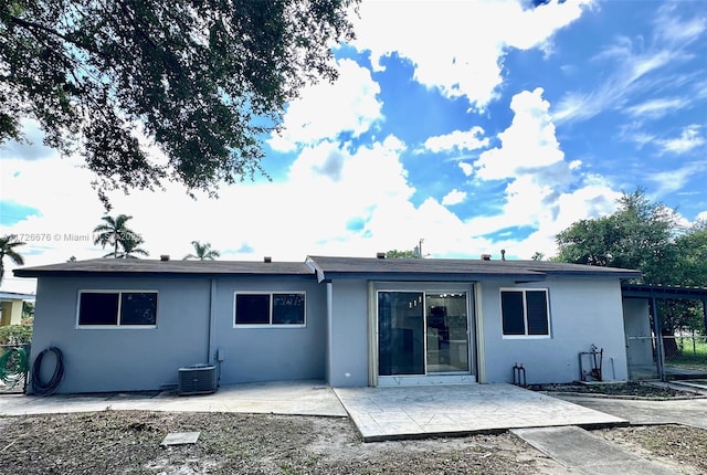 back of property featuring central AC unit and a patio