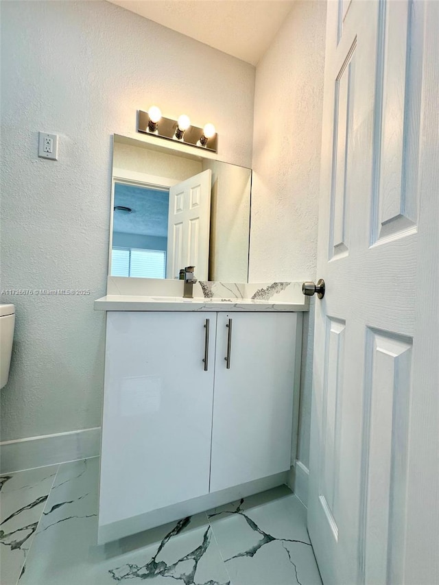 bathroom with toilet and vanity