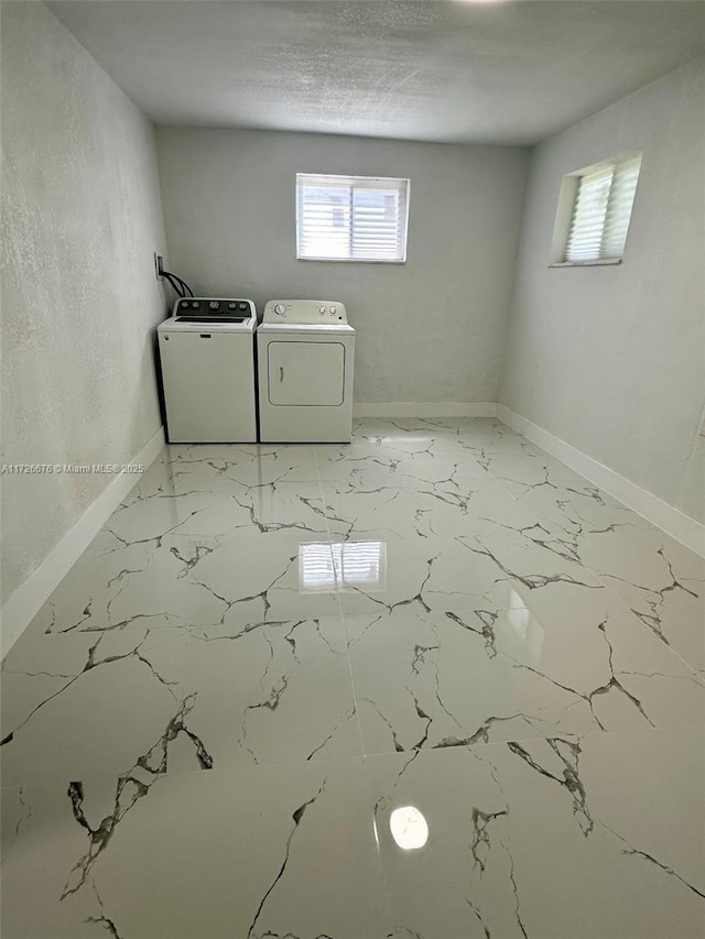 laundry area featuring washer and dryer and plenty of natural light