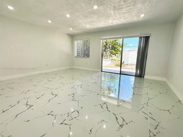 unfurnished room featuring a textured ceiling