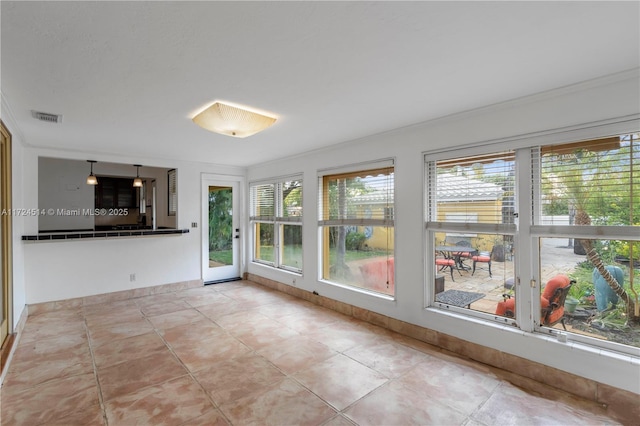 interior space featuring ornamental molding and a healthy amount of sunlight