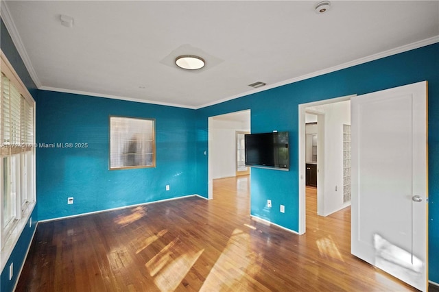 unfurnished bedroom featuring crown molding and hardwood / wood-style floors