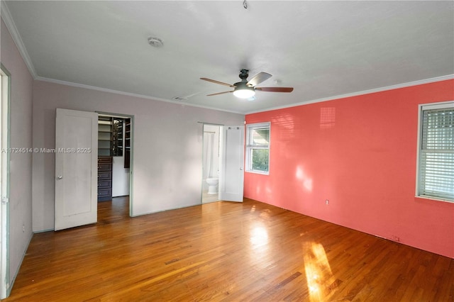 spare room featuring hardwood / wood-style flooring, crown molding, and ceiling fan