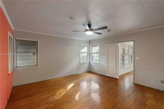 unfurnished room with crown molding, wood-type flooring, and ceiling fan