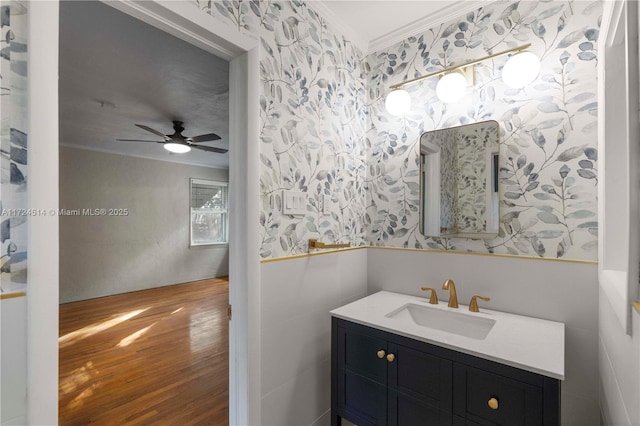 bathroom featuring crown molding, wood-type flooring, vanity, and ceiling fan