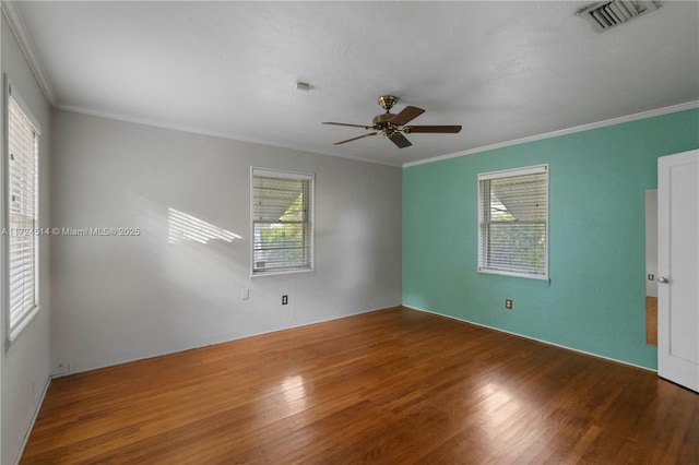 unfurnished room featuring hardwood / wood-style floors, crown molding, and ceiling fan