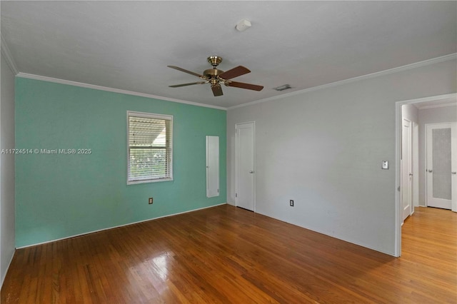 unfurnished room featuring hardwood / wood-style flooring, ornamental molding, and ceiling fan