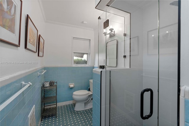 bathroom with tile walls, tile patterned flooring, ornamental molding, walk in shower, and toilet