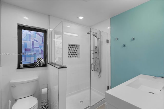 bathroom featuring walk in shower, sink, and toilet