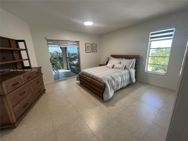 bedroom with access to exterior, multiple windows, baseboards, and light tile patterned floors