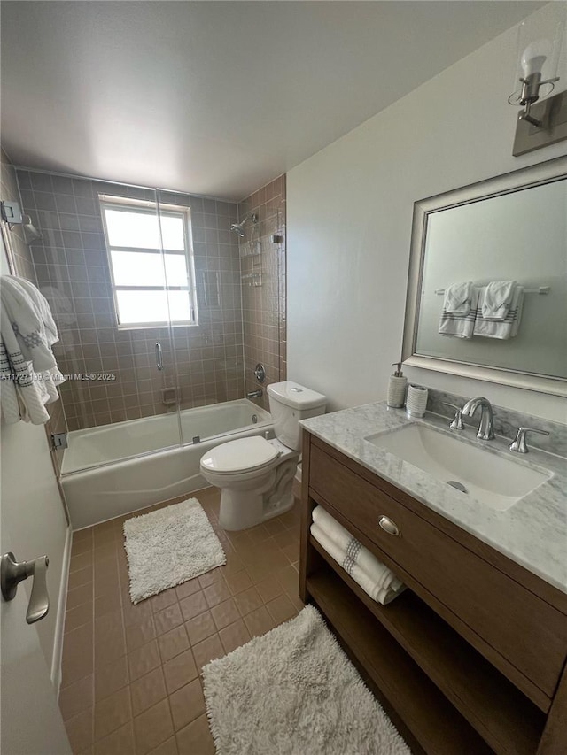 full bath with tile patterned flooring, bathing tub / shower combination, toilet, and vanity