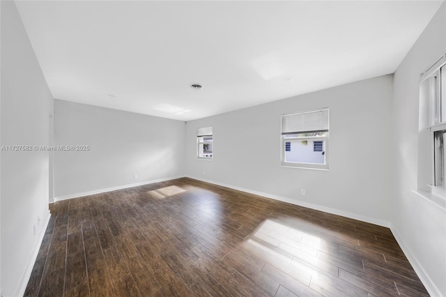 empty room with dark hardwood / wood-style floors