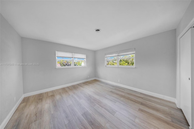 unfurnished room with light hardwood / wood-style flooring