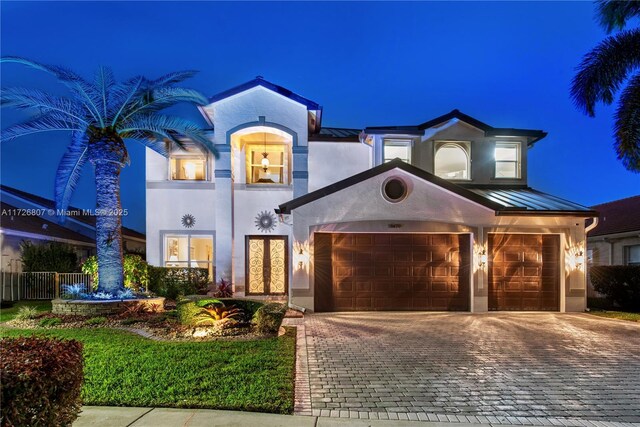 mediterranean / spanish home featuring a garage