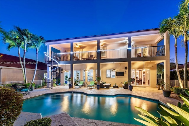 view of pool with a ceiling fan, a fenced in pool, a patio area, and stairway