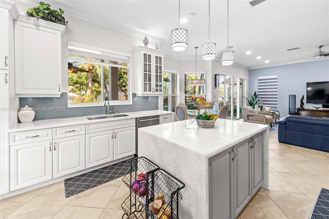 kitchen with glass insert cabinets, white cabinetry, and a sink