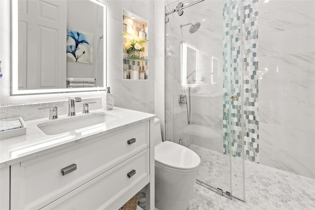 bathroom with vanity, a shower stall, and toilet