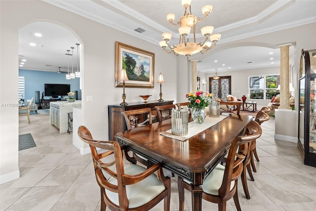 dining space featuring ornate columns, visible vents, a tray ceiling, and a chandelier