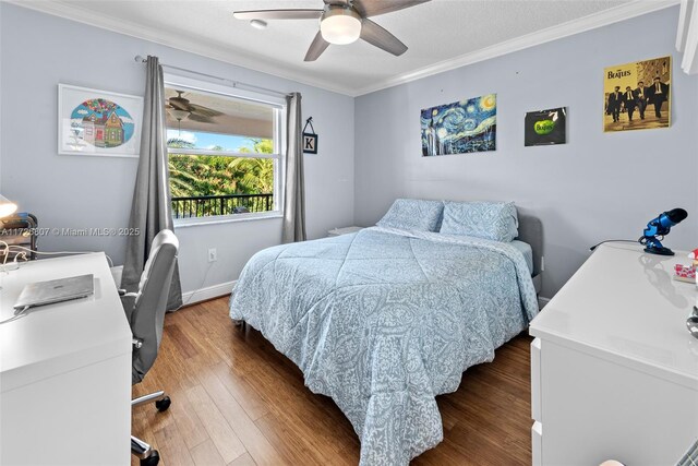 bedroom featuring baseboards, crown molding, a ceiling fan, and wood finished floors