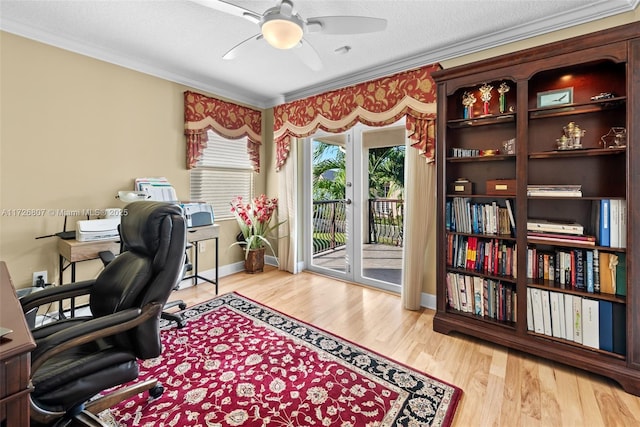 office area featuring ceiling fan, a textured ceiling, wood finished floors, baseboards, and crown molding