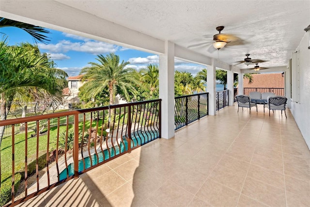 view of patio / terrace with a balcony and a ceiling fan