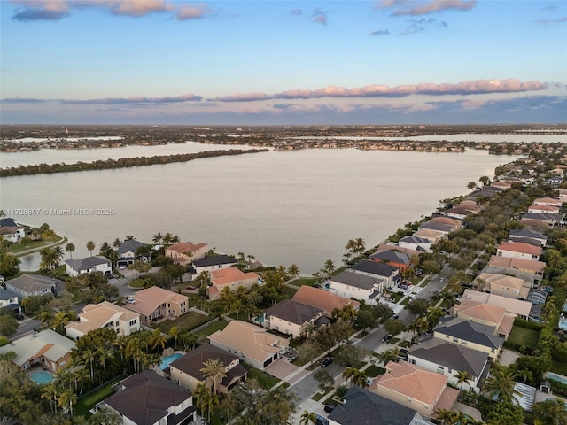 bird's eye view with a water view and a residential view