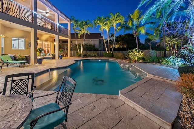 view of swimming pool with ceiling fan, a patio area, fence, and a fenced in pool