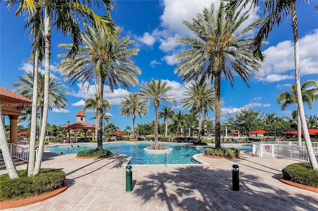 pool featuring a gazebo, a patio area, and fence