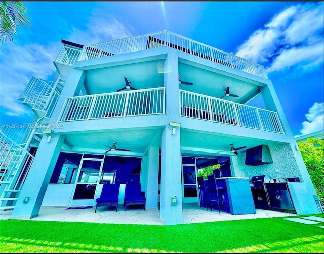 rear view of house featuring ceiling fan, a patio area, a bar, and a balcony