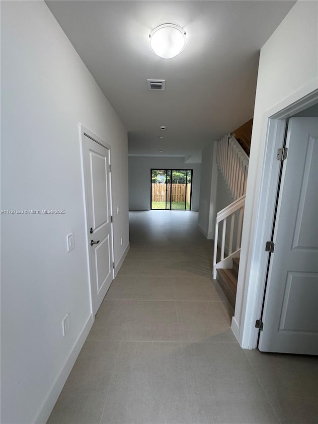 hall with light tile patterned flooring