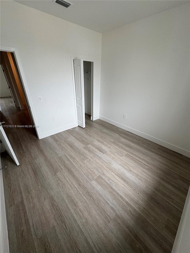 unfurnished bedroom with wood-type flooring