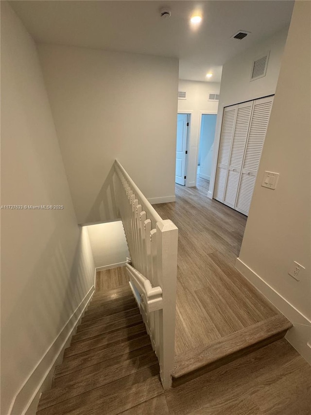 staircase featuring wood-type flooring