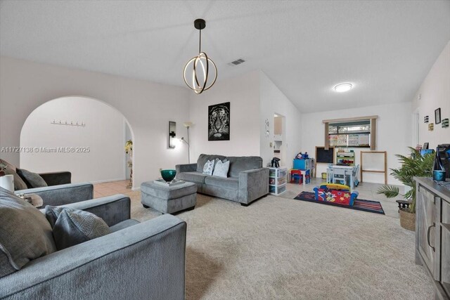 3270 Deer Lick, Kissimmee, FL 34746 - carpeted living room featuring an inviting chandelier, a textured ceiling, and lofted ceiling