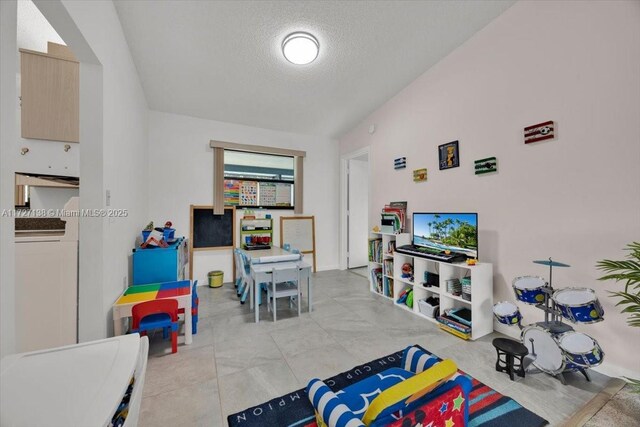 3270 Deer Lick, Kissimmee, FL 34746 - recreation room featuring a textured ceiling and washer / clothes dryer