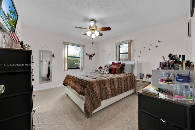 3270 Deer Lick, Kissimmee, FL 34746 - bedroom featuring multiple windows, a textured ceiling, light colored carpet, and ceiling fan