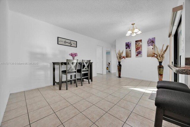 3270 Deer Lick, Kissimmee, FL 34746 - tiled dining space featuring a textured ceiling and a notable chandelier