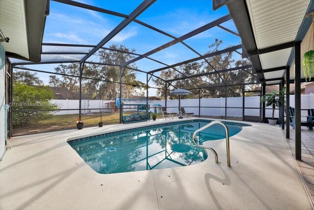 3270 Deer Lick, Kissimmee, FL 34746 - view of swimming pool with a patio and glass enclosure