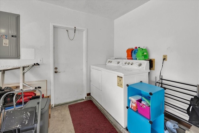 laundry room featuring a textured ceiling, electric panel, and washing machine and dryer