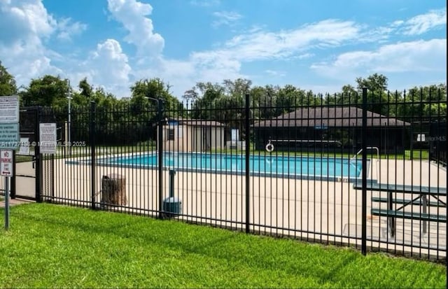 view of pool with a yard and a patio