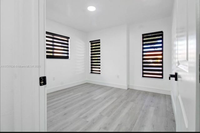 spare room with light hardwood / wood-style flooring