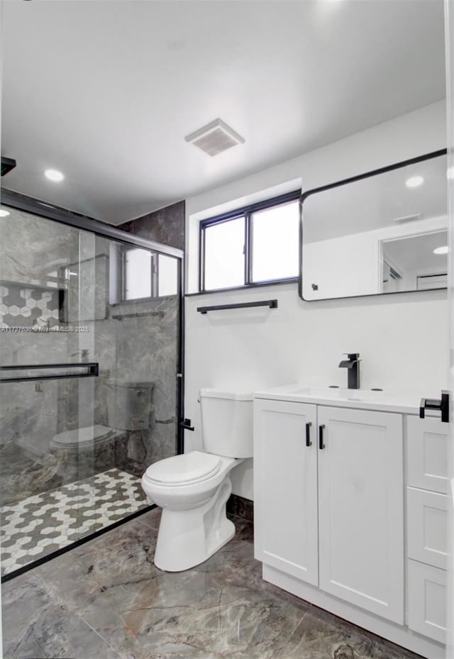 bathroom with toilet, walk in shower, and vanity