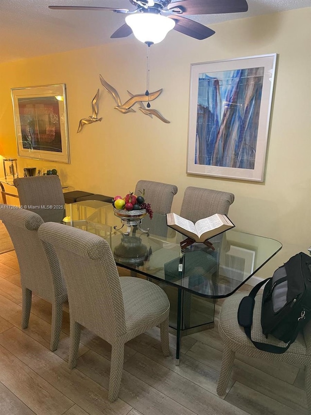 dining area featuring ceiling fan and hardwood / wood-style floors