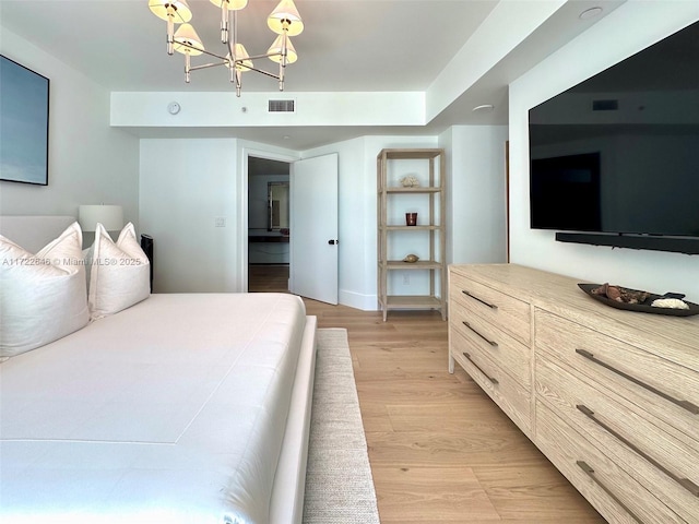 bedroom featuring a notable chandelier and light hardwood / wood-style floors