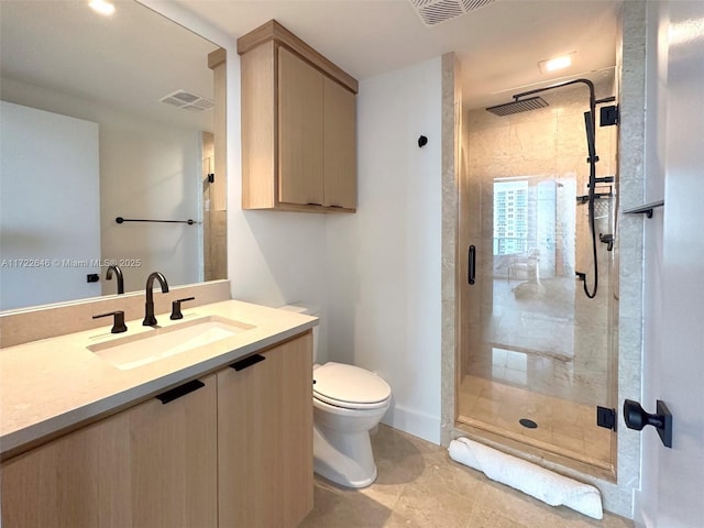 bathroom with an enclosed shower, vanity, and toilet