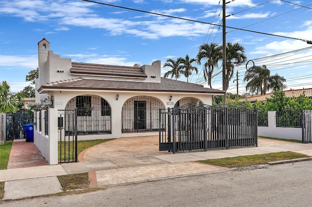 view of front of property featuring a fenced front yard, a gate, and stucco siding