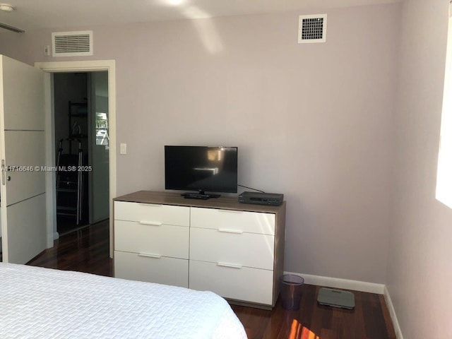 bedroom with a closet and dark hardwood / wood-style floors