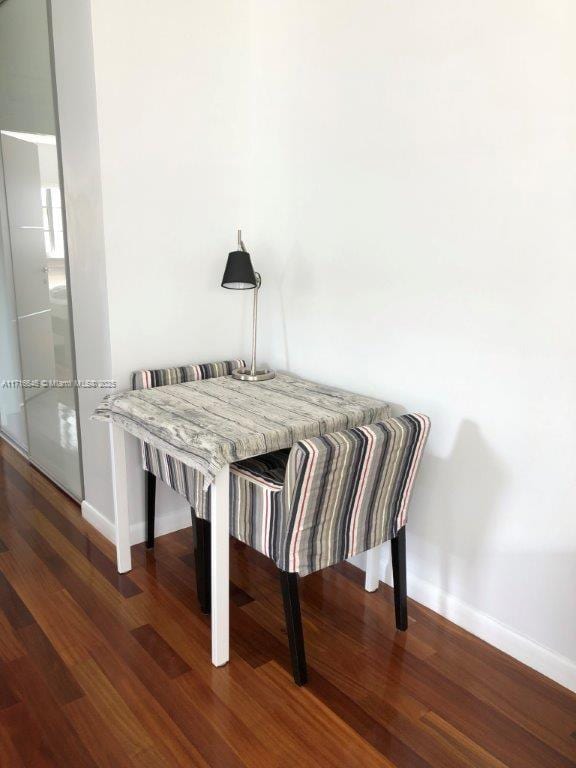 dining space with dark hardwood / wood-style floors