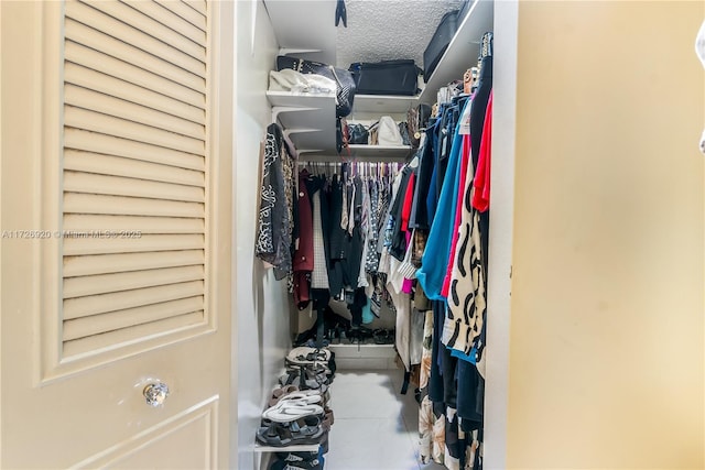 spacious closet featuring tile patterned flooring